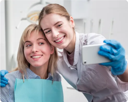 Dental hygienist taking a selfie with a patient Dental hygienist taking a selfie with a patient